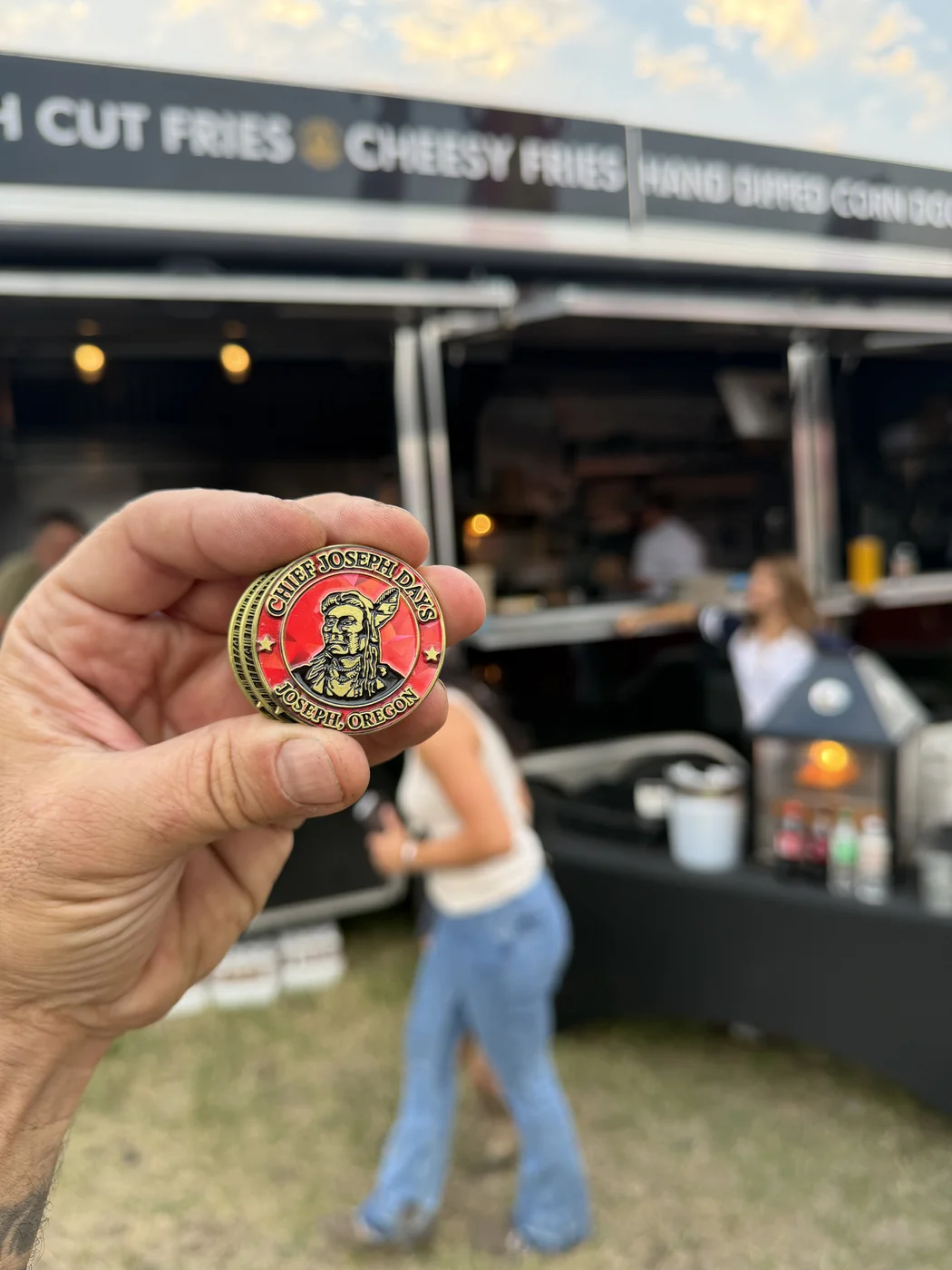 Chief Joseph Days commemorative coin held up in front of The Gravy Train