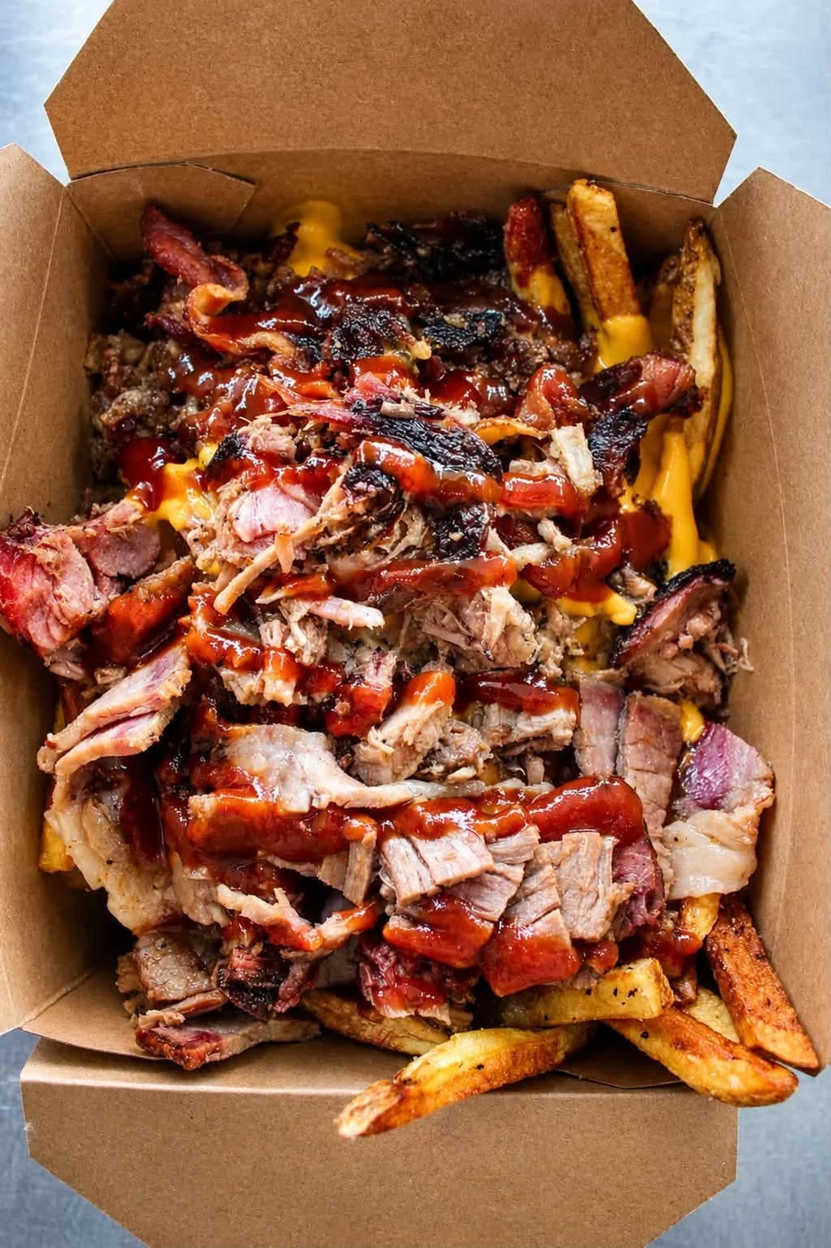 Chopped brisket over fries with BBQ sauce