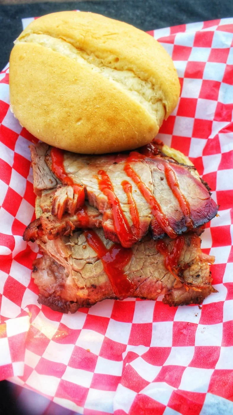 Brisket sandwich on a soft bun with BBQ sauce