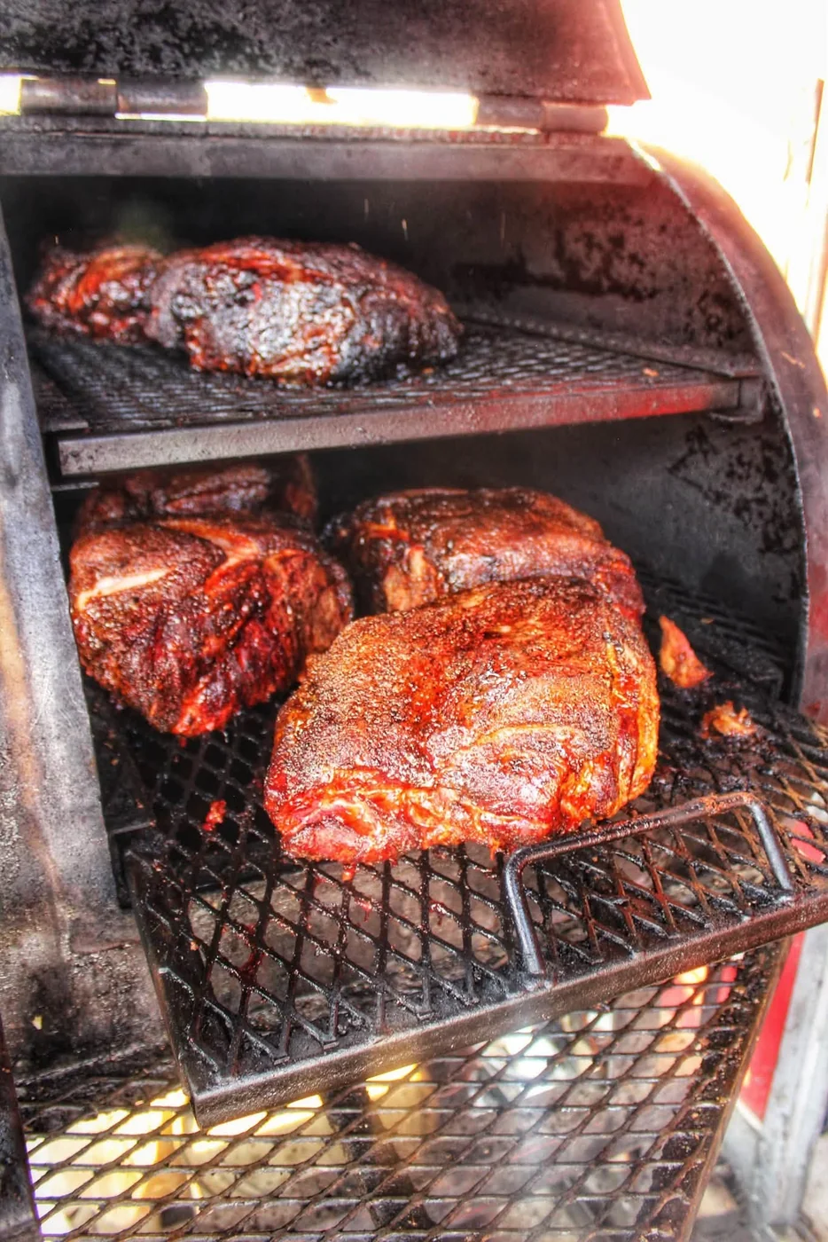 Pork shoulders smoking on the rack